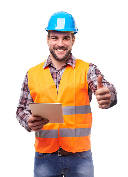 Smiling manual worker in blue helmet with digital tablet and gesture thumb up